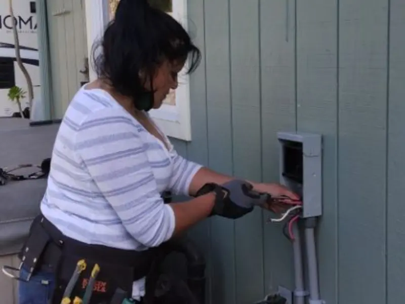 Licensed electrician wiring an exterior subpanel in Milton