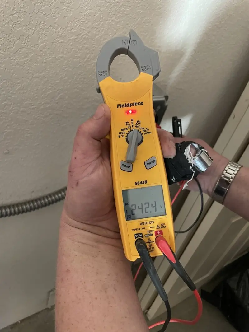 Voltage testing with clamp meter during Outlet Installation in Milton